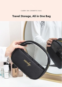 Detail of black PU leather cosmetic bag with transparent window and gold zipper pull