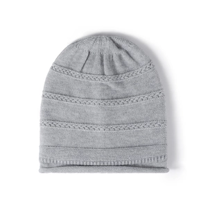 Thick grey cable knit beanie for women featuring a warm fleece lining and roll hem edge