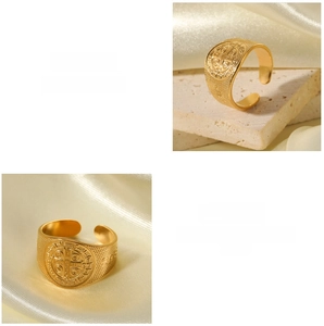 Macro view of 18K gold plated Saint Benedict Medal ring with grid embossed texture