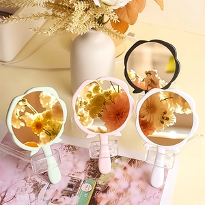 Mini rose-shaped handheld makeup mirrors in multiple colors with transparent stands