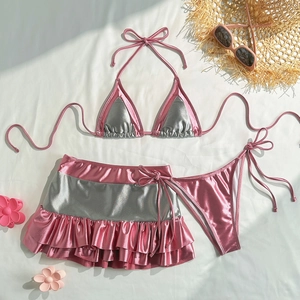 Three-piece metallic pink and silver bikini set with ruffled skirt and summer accessories