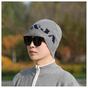 Detail of grey ribbed knit beanie with navy blue jacquard lettering and soft texture