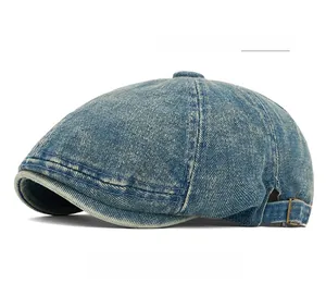 Detail of vintage dark blue washed denim beret featuring metal side adjustment buckles