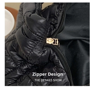 Close-up of golden metal zipper on black quilted glossy nylon shoulder bag detail
