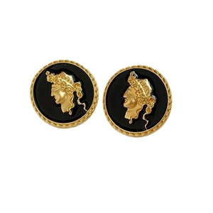 Vintage gold cameo earrings with black base and classical portrait relief on white background