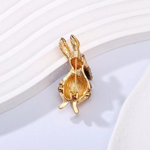 Detail view of the golden rabbit brooch back showing secure pin closure mechanism