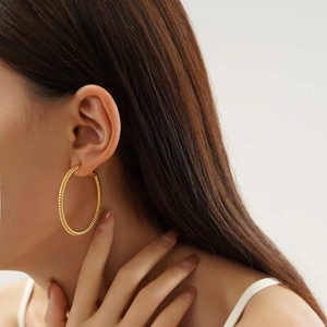 Chic 18k gold plated stainless steel spiral hoop earrings on female model