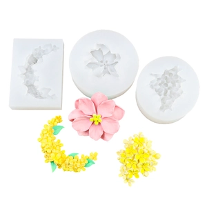 Silicone flower molds and finished clay crafts including moon and orchid floral shapes