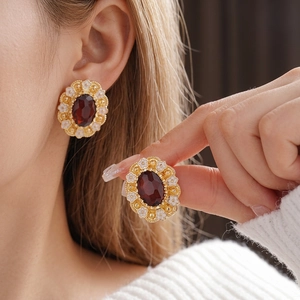 Vintage style floral earrings with oval ruby gemstone and white enamel petals