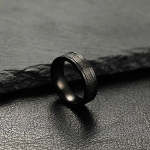 6mm black stainless steel roman numeral ring displayed on grey stone background