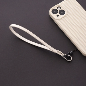 Detailed view of off-white PU leather phone wrist strap with silver metal clasp hardware