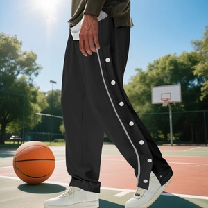 Detail of black baggy basketball sweatpants with side snap buttons and white stripes