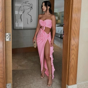 Detail of pink strapless top and slit skirt set with 3D floral accent and ruching