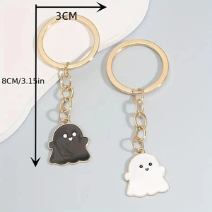 Detailed view of Halloween ghost keychain pendants with dimension markings in gold finish