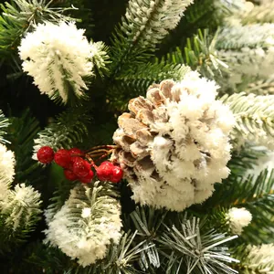 Flocked pine cone with red berries and snow coating for festive Christmas decoration