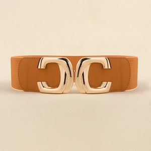 Close-up of golden double C buckle on a brown wide elastic waist belt for women
