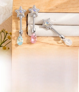 Detail of star-shaped titanium steel ear stud with colorful cubic zirconia teardrop