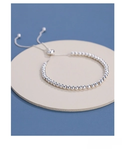 Macro detail of S925 sterling silver beaded bracelet with adjustable drawstring closure