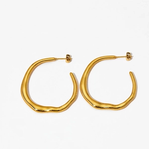 Detail of gold plated stainless steel irregular hoop earrings with liquid metal texture