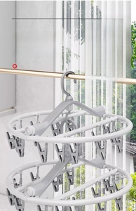 Detail of 360-degree rotating hook and bottom link on gray multi-clip laundry rack