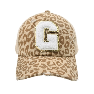Detailed view of leopard print baseball cap with chenille G patch and gold glitter edge