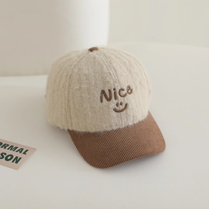 Detail of nice embroidery and smiley face on plush and corduroy baseball cap
