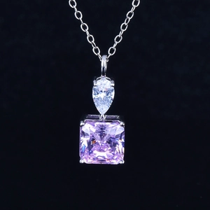 Detail showing a pink radiant cut carbon diamond pendant on a silver necklace