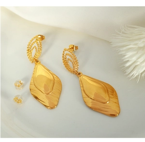 Close-up of 18k gold plated drop-shaped earrings with polished and brushed metal texture