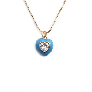 Fashionable gold plated necklace featuring a heart shaped blue pendant with a faceted gemstone