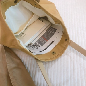 Minimalist khaki canvas tote bag with magnetic closure and spacious interior pocket