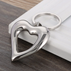 Polished silver stainless steel hollow heart keychain pendant with a metallic finish