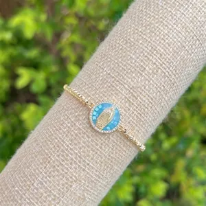 Macro shot of 18K gold plated twisted chain bracelet with Virgin Mary pendant and zircon stones