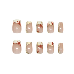 Handmade press-on nails featuring creamy French tips with gold lines and maple leaf design
