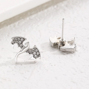 Macro shot of silver bat stud earrings with sparkling rhinestones and clean metal finish