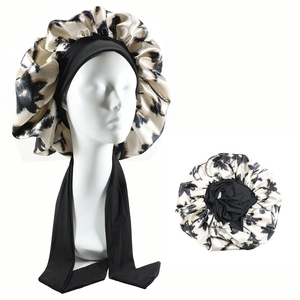 Detail of satin sleep bonnet with leopard print and wide elastic wrap-around bands
