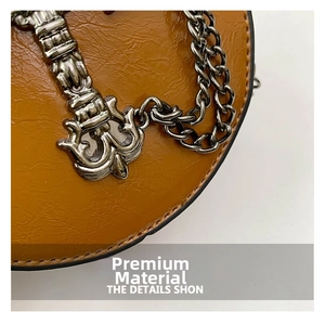 Macro detail of brown lychee grain leather texture and vintage gothic metal hardware