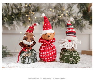Three Christmas character drawstring gift bags featuring fox, bear and Santa Claus
