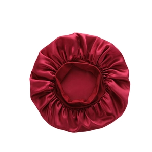 Detailed texture of burgundy satin sleep cap with elastic wide band and smooth finish