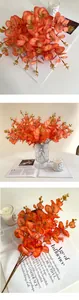 Macro shot of faux orange eucalyptus leaves with gradient texture for autumn home decor