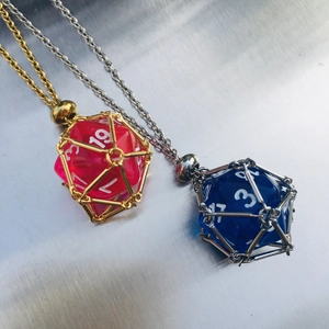 Detailed close-up of D20 dice necklaces in metal cage pendants with gold and silver chains