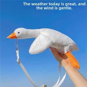 Close-up of cute white goose plush bag featuring soft texture and orange beak detail