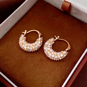 Elegant 18k gold plated C-hoop earrings featuring pearls and crystals on dark velvet
