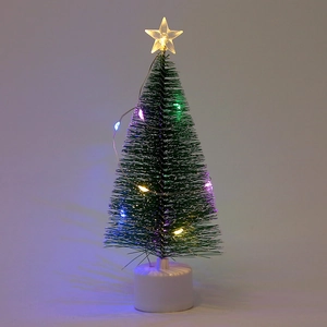 Detailed close-up of a mini Christmas tree with glowing colorful LED lights and star topper