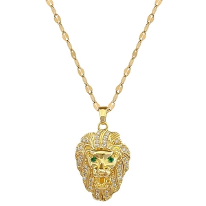 Luxury gold lion head necklace with sparkling diamonds and green eyes on white background