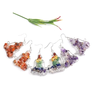 Detail of handmade wire-wrapped yoga earrings with natural colorful crystal stones