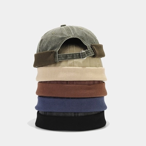 Vertical stack of multi-color cotton docker caps with adjustable metal back buckles