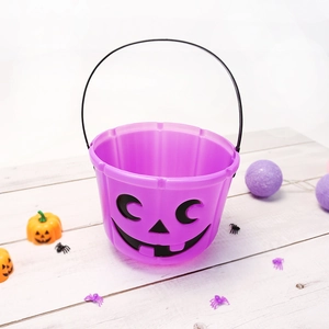 Purple plastic Halloween pumpkin candy bucket with black handle and carved face design