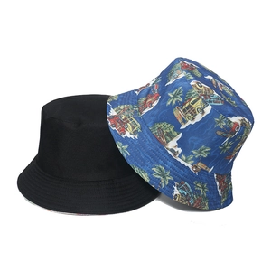 Detail of classic black and blue tropical palm tree print bucket hats for sun protection