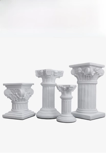 Set of four white resin Roman pillars with diverse classical carvings for wedding decor