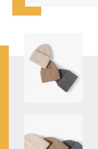 Detailed ribbed texture of winter knit beanies in beige, brown and dark grey